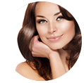 Brown haired woman touching her face