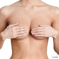 Woman covering breast with hands