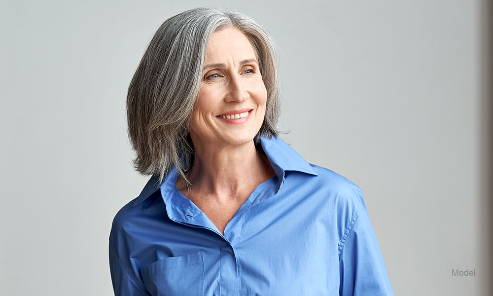 Mature woman in a blue shirt outdoors